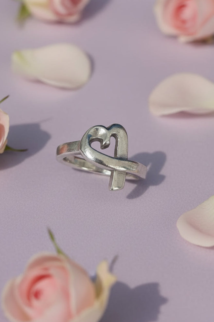 Silver Heart ring with pink flowers on a lilac background. Authentic Paloma Picasso Tiffany & Co. ring