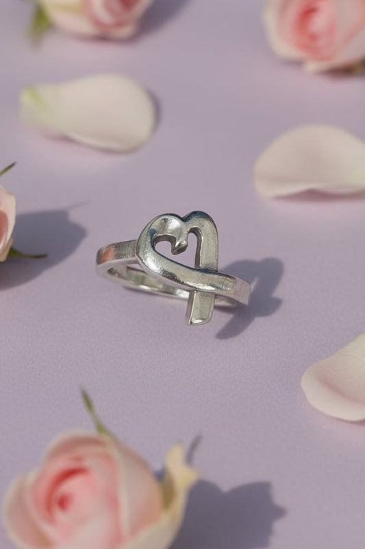 Silver Heart ring with pink flowers on a lilac background. Authentic Paloma Picasso Tiffany & Co. ring