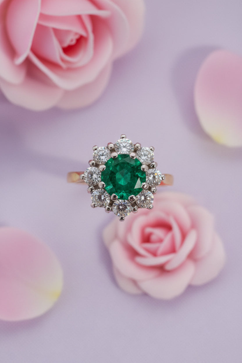 Ring with an emerald and diamonds on a light background