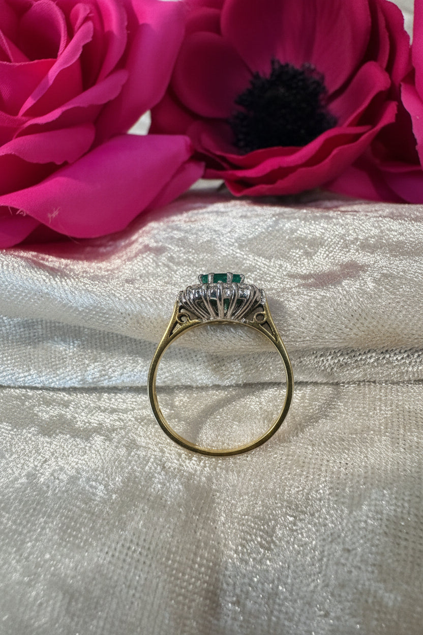 Gold ring with gemstone on a textured silver surface