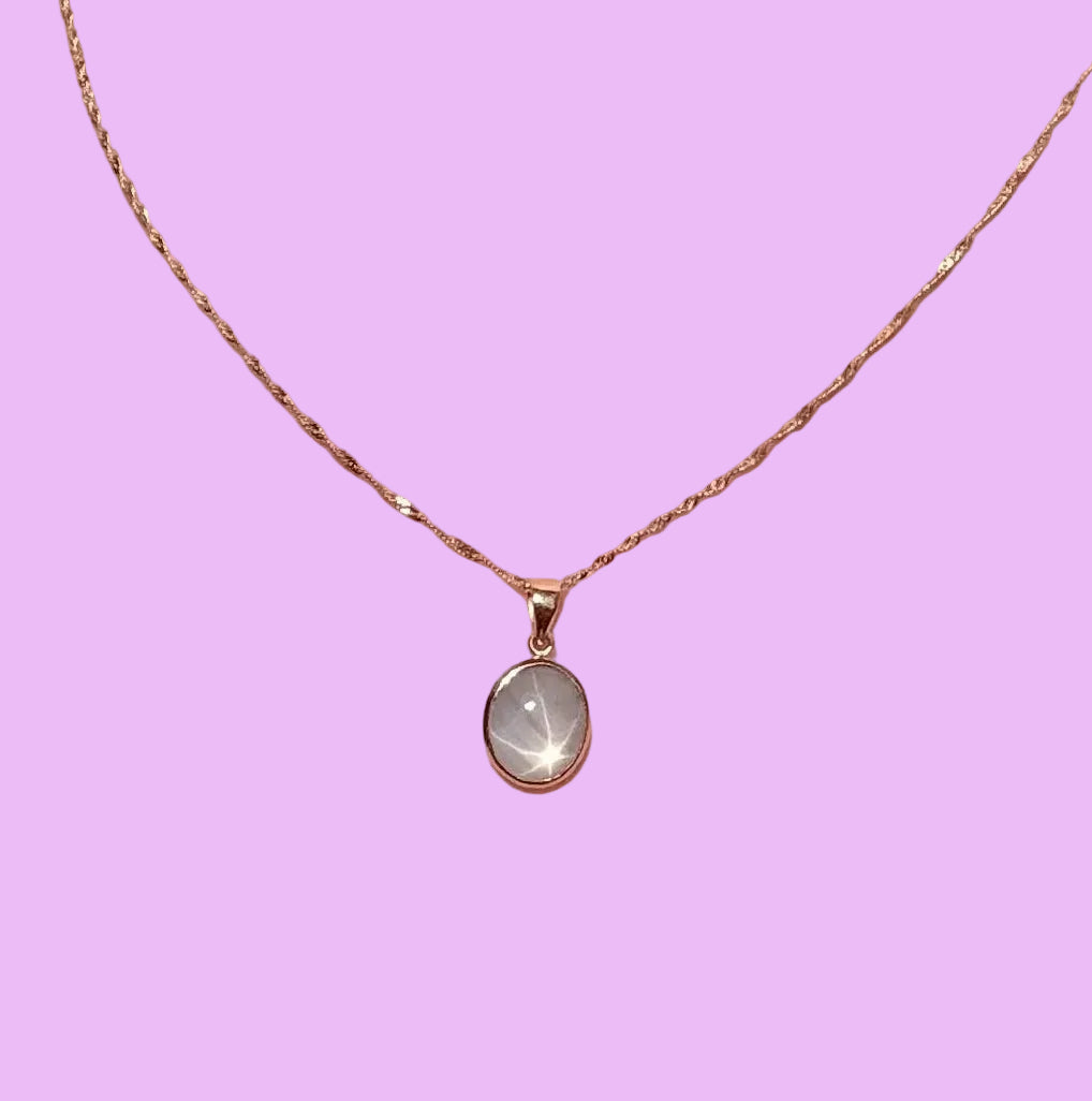 star sapphire Necklace on a pink background