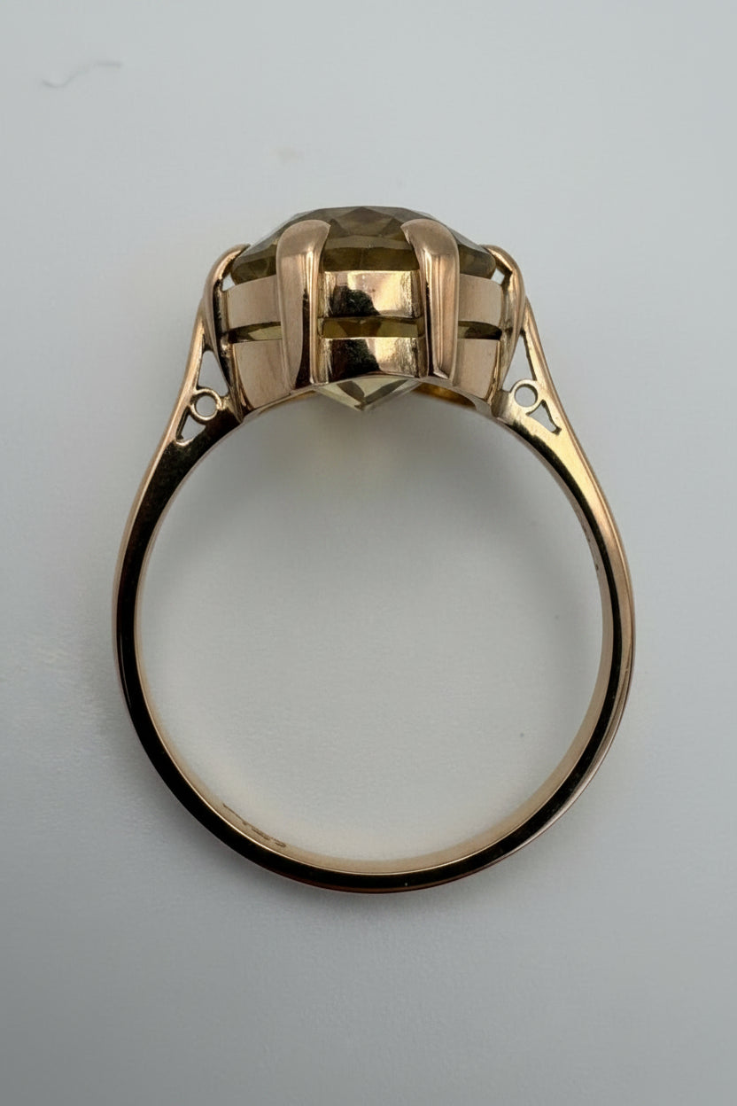 A vintage-style yellow gold ring with a large rectangular cluster of clear stones in a prong setting, shown on a plain light gray background.